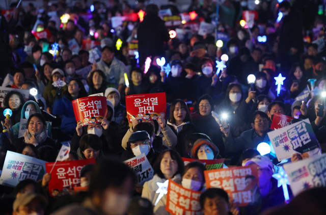 13일 서울 종로구 광화문 동십자각 앞에서 열린 야5당 공동 비상시국 범국민대회에서 참가자들이 윤석열 대통령 파면을 촉구하며 응원봉을 흔들고 있다. 연합뉴스