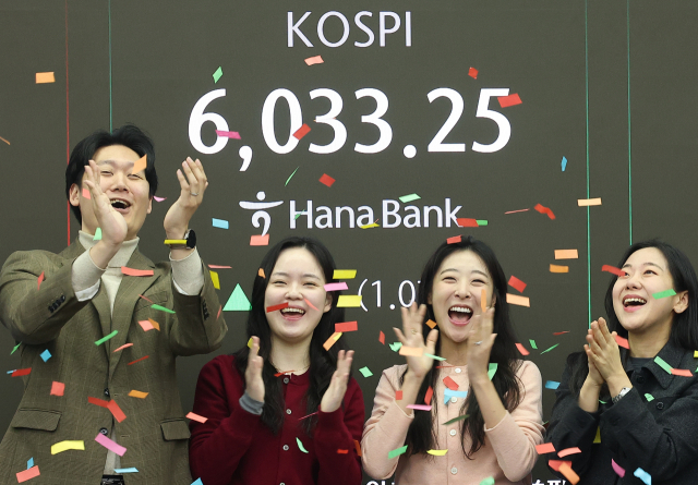 코스피가 장중 6000을 넘어선 가운데 25일 서울 중구 하나은행 본점 딜링룸에서 직원들이 기뻐하고 있다. 연합뉴스