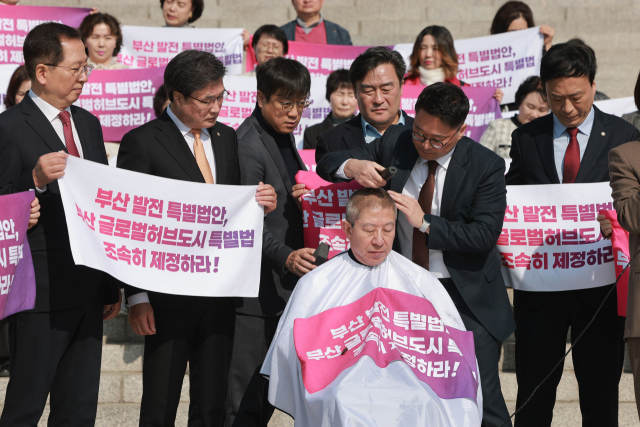 박형준 부산시장이 부산 글로벌 허브도시 특별법 제정을 촉구하며 지난 23일 국회 본청 앞 계단에서 삭발을 단행했다. 국민의힘은 민주당이 선거를 목전에 두고 입장을 바꿨다며 비판했다. 연합뉴스